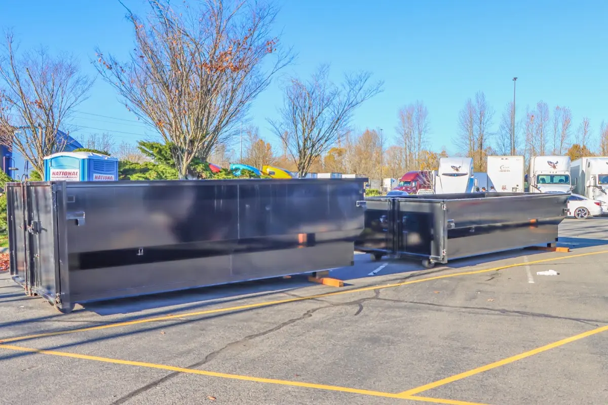 Professional dumpster rental service with roll-off container on residential driveway in McHenry